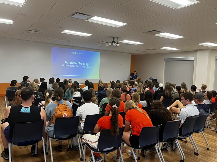 Volunteers watching a presentation.