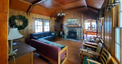 Lodge building living area with couches and fireplace